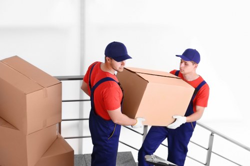 Queenspark Man And Van team loading furniture safely with protective equipment