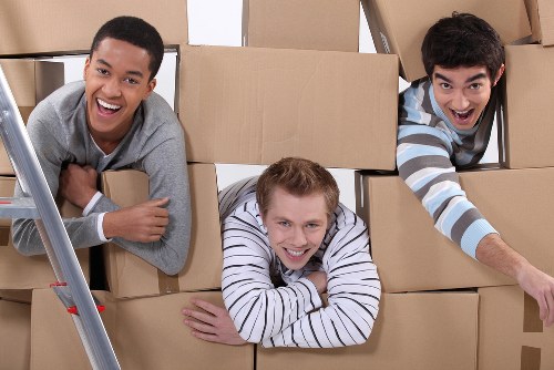 Packing boxes and furniture for a moving truck in Queenspark