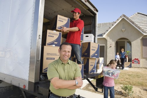Man and van truck with reusable household items and recycling boxes