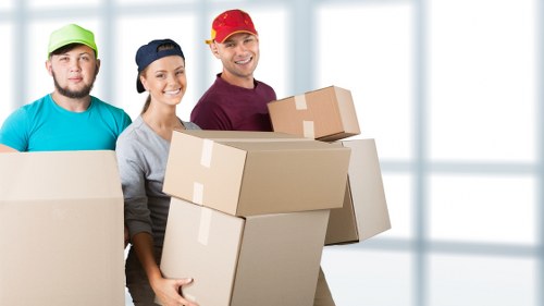 Movers carrying furniture safely during a Queenspark flat removal service