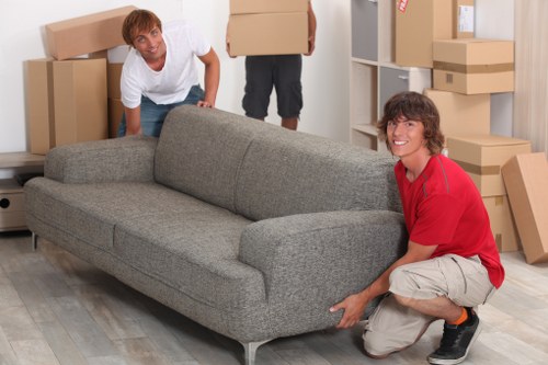 Removal van loading office furniture on a residential street in Queens Park