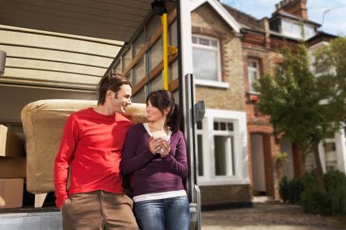 Professional movers packing household items for a Queenspark relocation